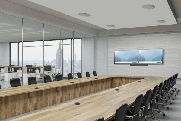 A large conference room with two displays, in-ceiling speakers, and microphones.
